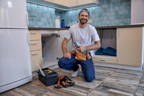 istock Handsome caucasian male plumber sitting next to open kitchen drawer 1280468250