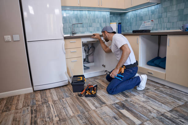 istock Young caucasian service man looking into drawer with pipes 1280468258