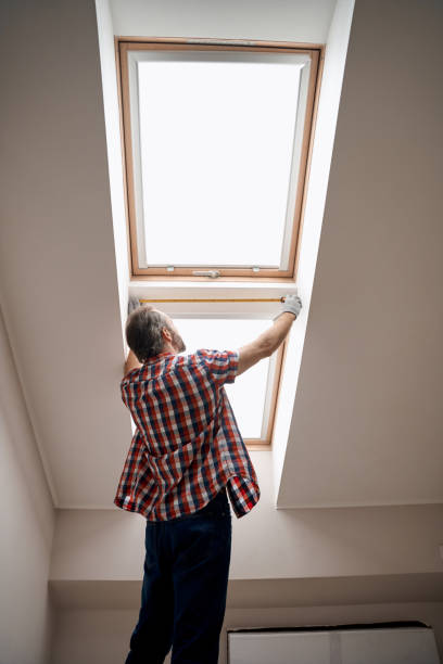 istock Back view of worker leaning measuring tape on window 1280468291