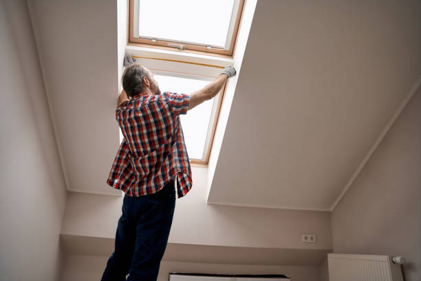 istock Repairman with measuring tape next to skylight window 1280468293