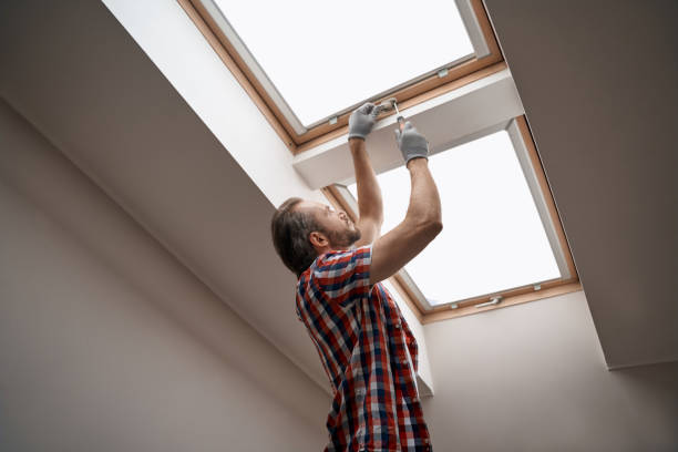Young caucasian worker screwing skylight window handle stock photo