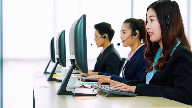 istock Business people wearing headset working in office 1280469732
