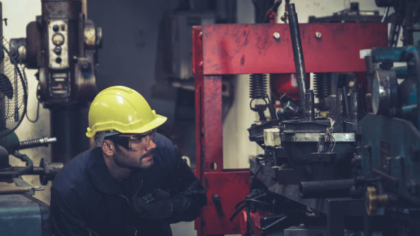 istock Factory worker talking on portable radio while inspecting machinery parts 1280473066