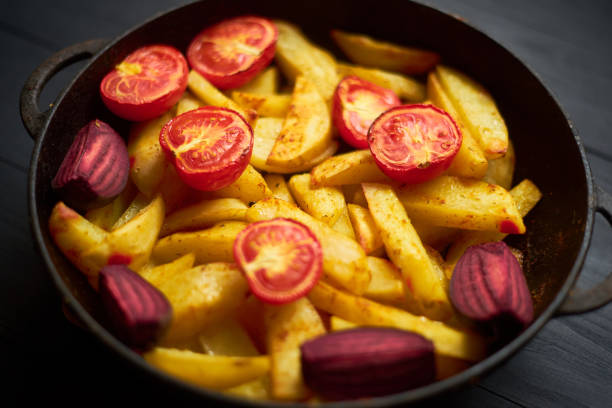 Baked potato with meat, tomatoes, beetroot in the oven.