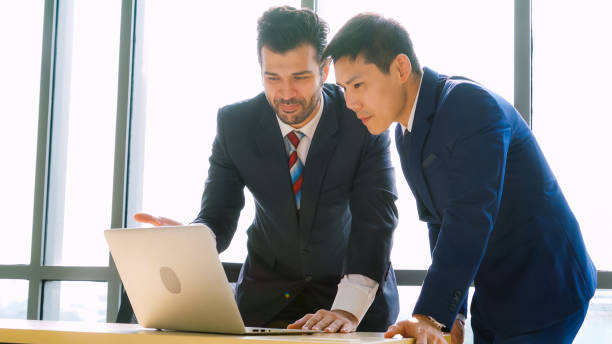 istock Two business people talk project strategy at office 1280476058