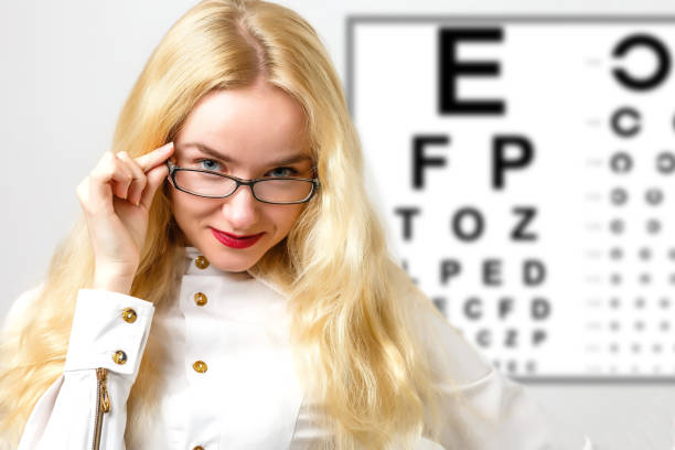 istock Beautiful woman with laser hologram and test vision table 1280476428