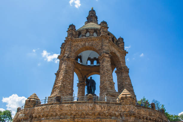 Porta Westfalica, Germany - June 22 2020: The Emperor William Monument near the city of Porta Westfalica, North Rhine Westphalia in Germany. Only a few people visit the sight on a sunny summer day
