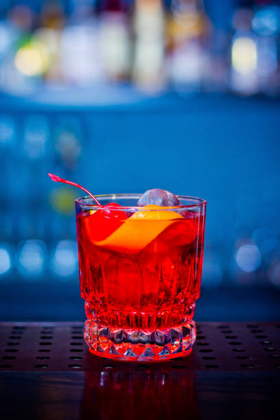 istock Red drink cocktail in glass jar with cherry and orange peel 1280477699