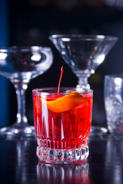 istock Red drink cocktail in glass jar with cherry and orange peel 1280477706
