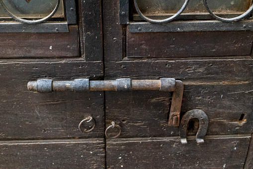 vintage latch on a historic door with signs of rust