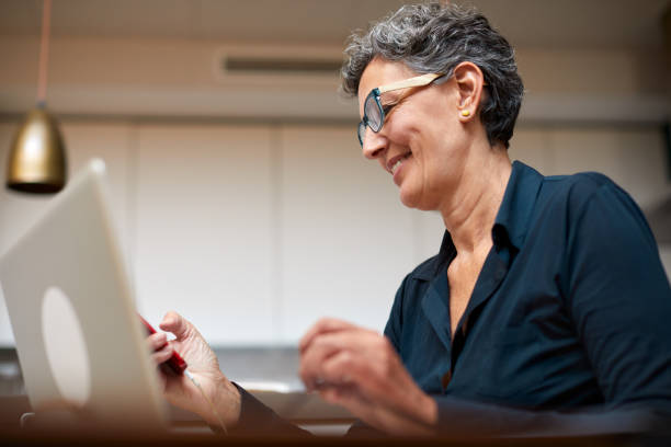 istock Middle-aged Caucasian woman working from and texting on a smart phone. 1280478516