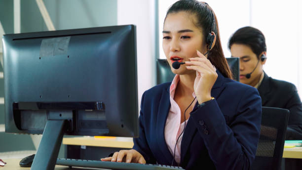 istock Business people wearing headset working in office 1280479050