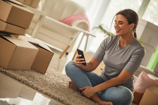 istock Young woman taking a break from unpacking into her new apartment 1280479750