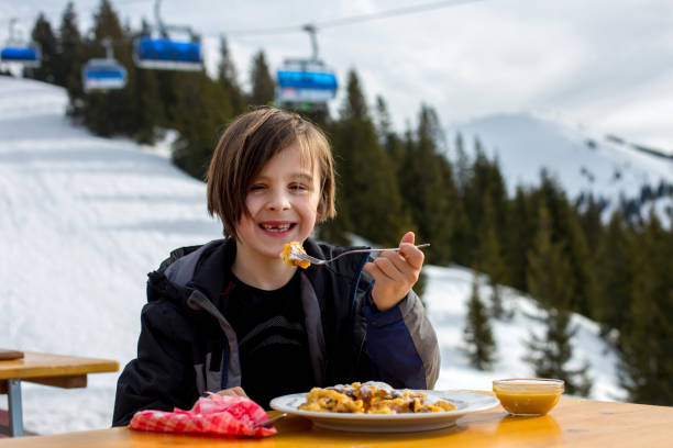 istock Child, eating sweet desert in a restaurant while having break from skiing 1280479795