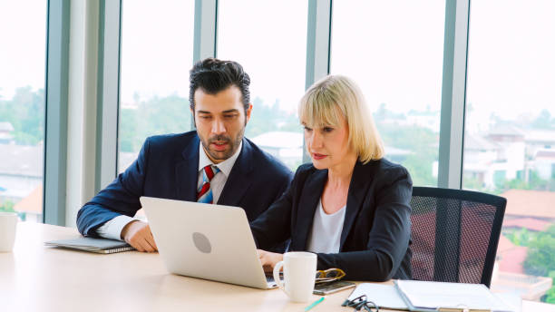 istock Two business people talk project strategy at office 1280479946