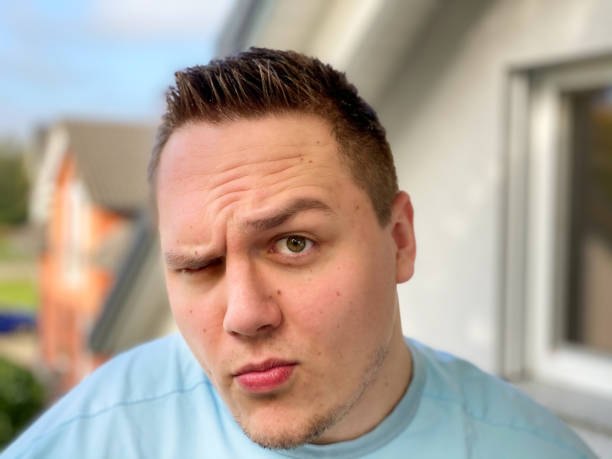 istock Quizzical young man raising an eyebrow 1280481948