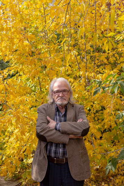 istock elegantly dressed grandfather walking in the autumn forest 1280482523