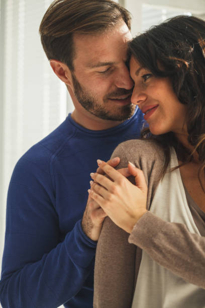 istock Romantic mid adult couple cuddling 1280483558