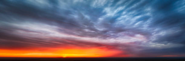 istock Panorama of an epic dramatic sunset in the sky among the black clouds 1280486202