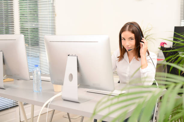 istock young beautiful woman telephone operator with headset working on desktop computer in a customer service call support helpline business center 1280486278