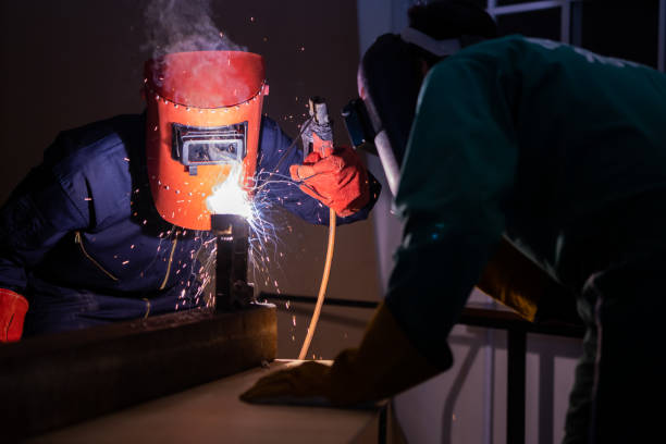 istock Metal welding steel works using electric arc welding machine 1280488508