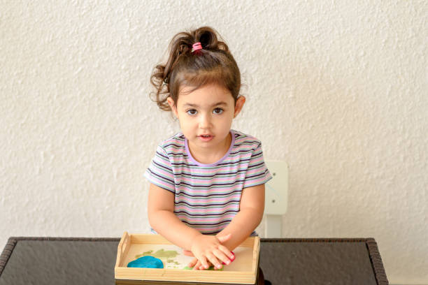 children creativity. kid sculpts from clay. cute little girl moulds from plasticine on table - sculpture clay human face human head imagens e fotografias de stock