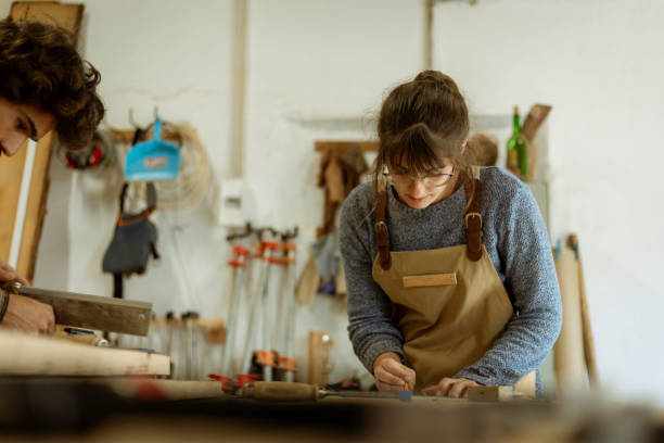 istock young female carpenter working as wood designer in a small carpentry workshop 1280491281