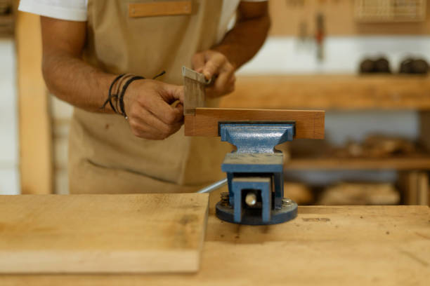 istock Close up of a young man working as carpenter in small carpentry workshop. 1280491299
