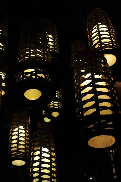 istock Retro design lamps with geometrical patterns with yellow light penetrating darkness 1280491363