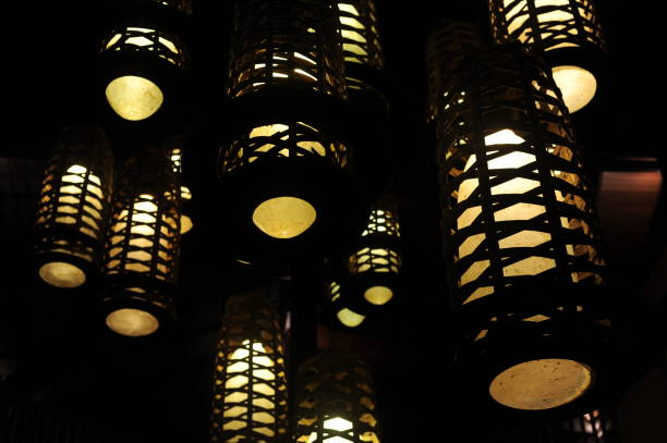 istock Retro design lamps with geometrical patterns with yellow light penetrating darkness 1280491406
