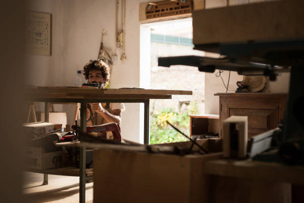 istock Hispanic man working as carpenter in a small wood laboratory. 1280491472