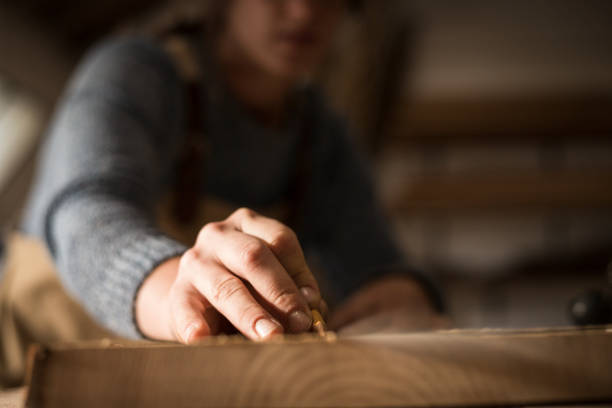 istock A young female carpenter working as wood designer in a small carpentry workshop 1280491598
