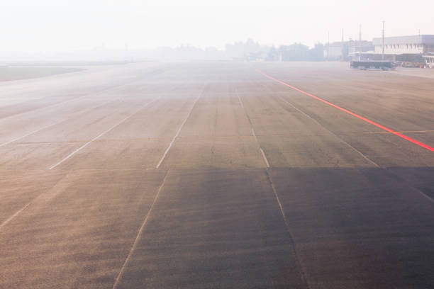 istock runway in the foggy day 1280492222