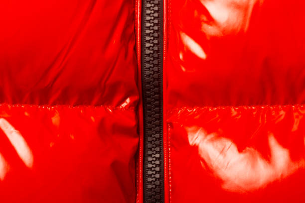 istock Red smooth glossy weave and black zipper. It can be used as a texture. Banner. Top view, flat lay 1280493409