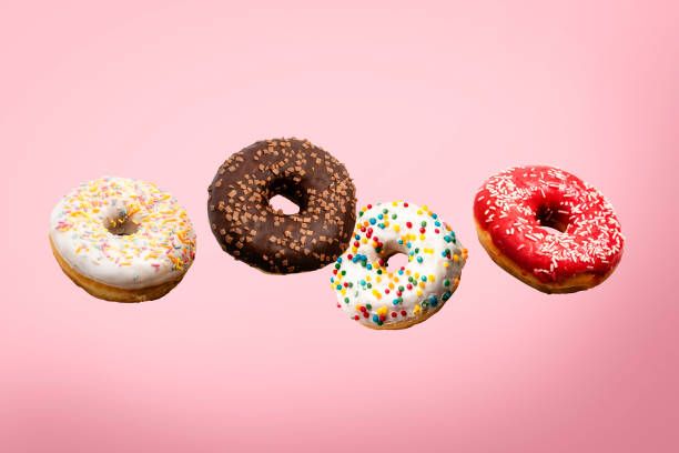 istock Donuts flying in the air on a pink background. Bakery, baking concept. Levitation. Banner 1280493462
