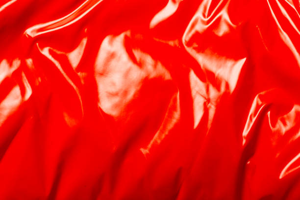 istock red smooth glossy weave. It can be used as a texture. Banner. Top view, flat lay 1280493685