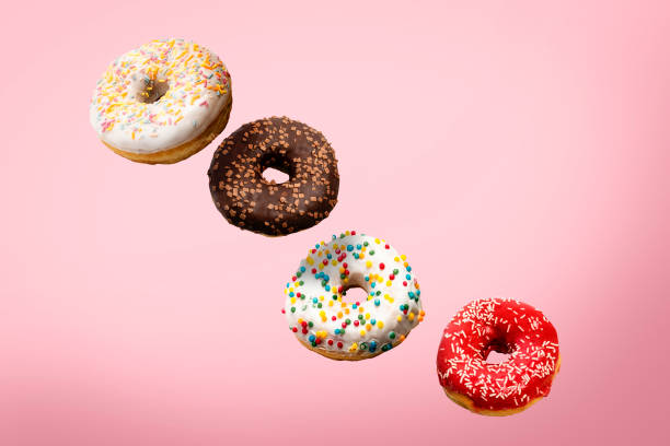 istock Donuts flying in the air on a pink background. Bakery, baking concept. Levitation. Banner 1280494221