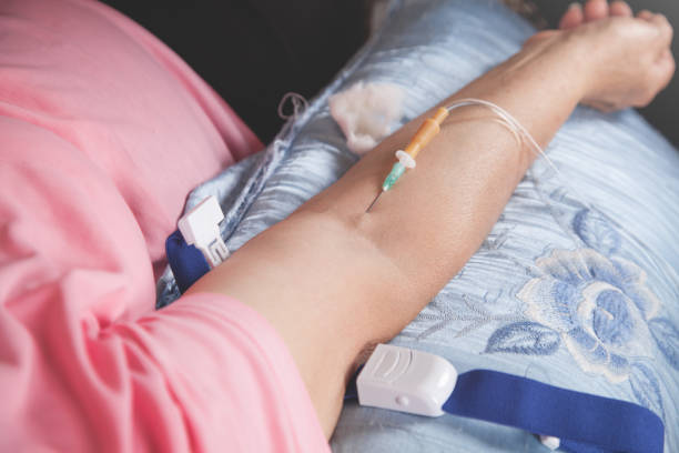 istock Intravenous drip into patient arm at home. 1280495351