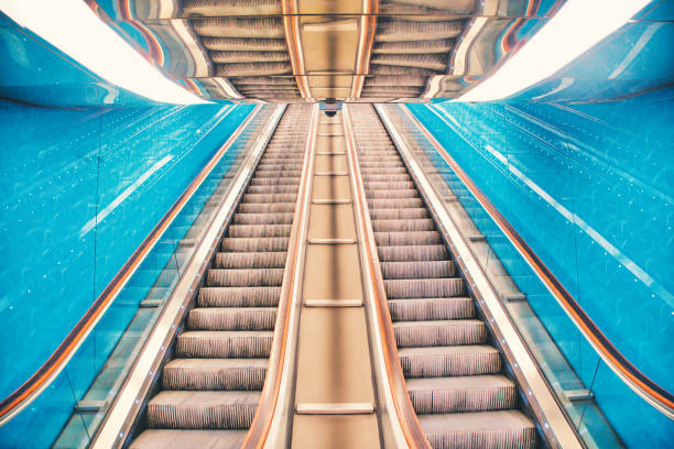 Rolling staircase, blue illuminated at a metro/underground station in Naples, Italy.