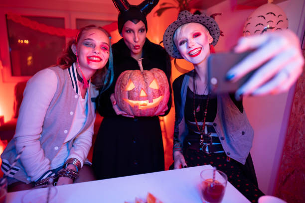 istock Girlfriends at the Halloween party, having fun and taking selfies 1280496578