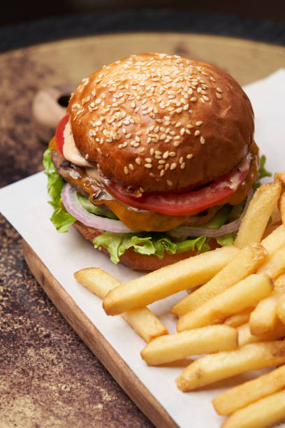 istock Cheeseburger with french fries and sauces 1280497009
