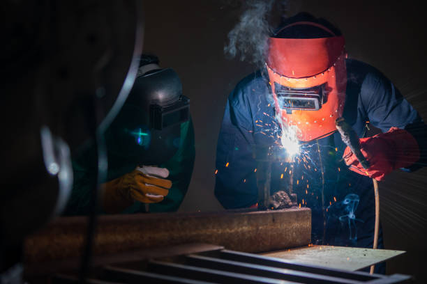 istock Metal welding steel works using electric arc welding machine 1280497568