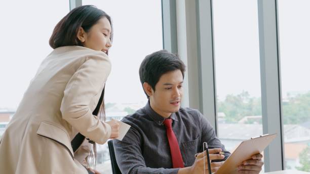 istock Two business people talk project strategy at office 1280499397