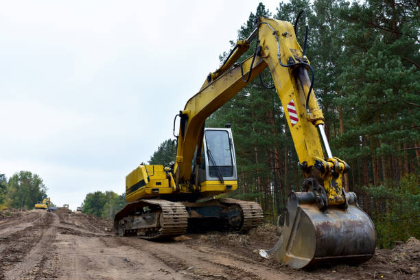 istock Excavator during construction new road in forest area. Yellow backhoe at groundwork. 1280499875