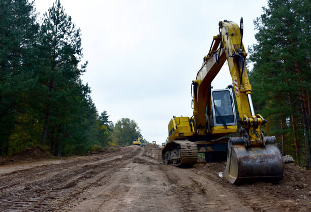 istock Excavator during construction new road in forest area. Yellow backhoe at groundwork. 1280499939