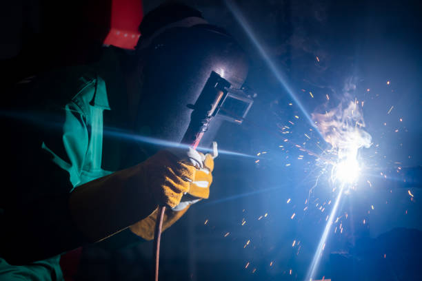 istock Metal welding steel works using electric arc welding machine 1280499992