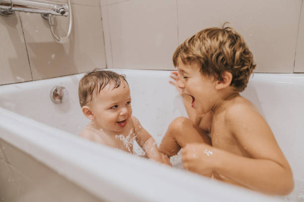 istock Brothers playing in the bathtub 1280501175