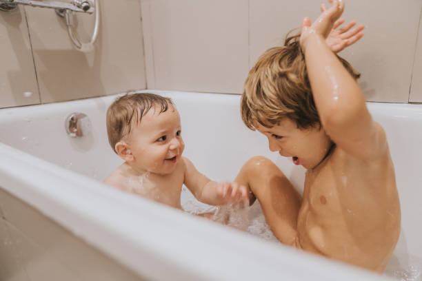 istock Brothers playing in the bathtub 1280501250