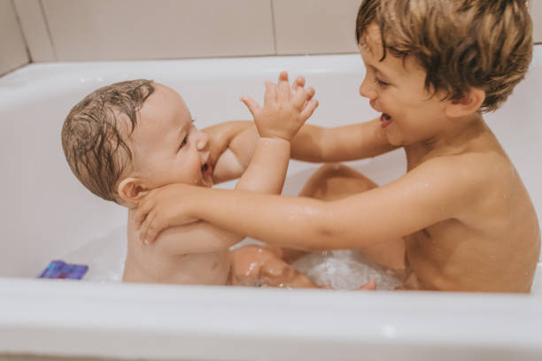 istock Brothers playing in the bathtub 1280501274