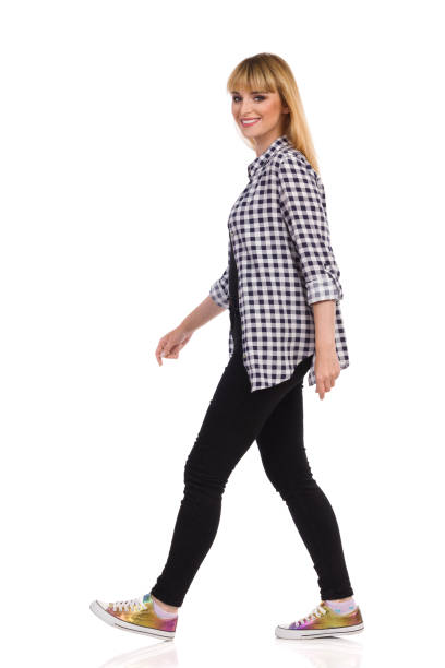 istock Happy Casual Woman Is Walking And Looking At Camera. Side View. 1280503635